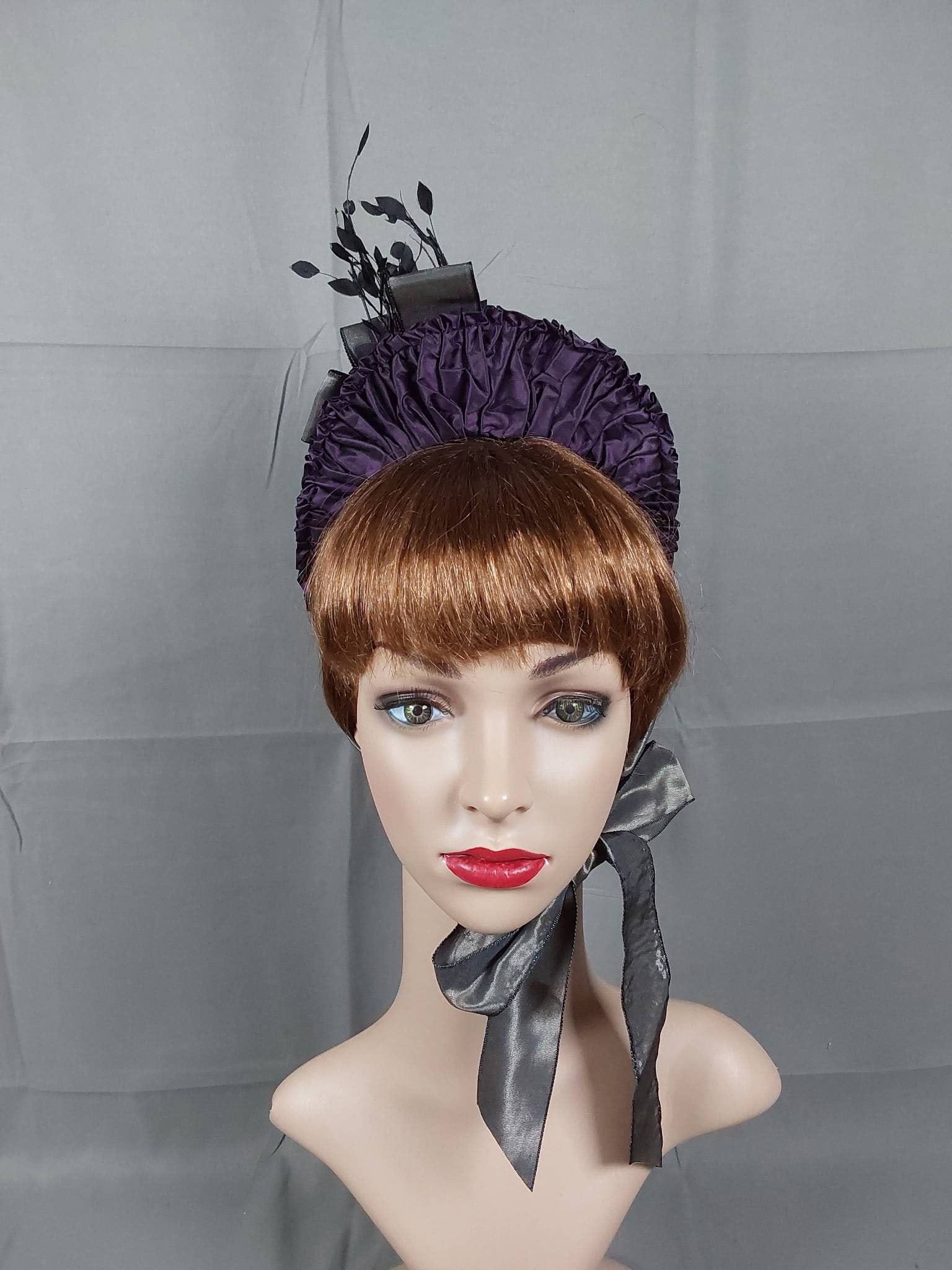 Antique 1880s Plum Silk Taffeta Bonnet: The bonnet was crafted in plum silk taffeta with taupe silk taffeta ribbon bows and trim. A cut steel buckle accent and a spray of black silk leaves add intricate detailing. The bonnet further feature
