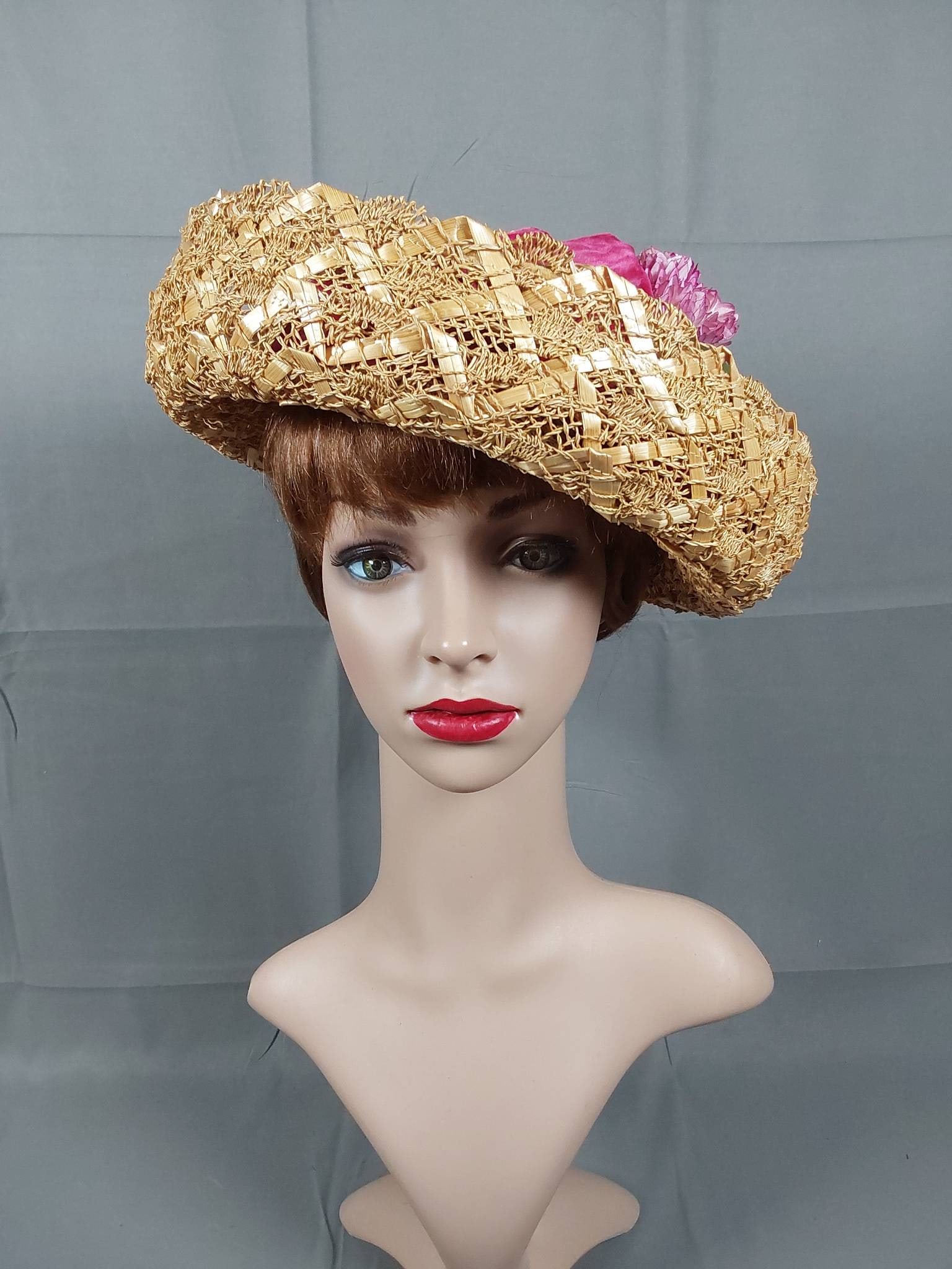 Antique Edwardian Blonde Straw Hat: An Edwardian blonde straw hat showcasing a lattice fan woven design. The hat includes an upturned brim with a rounded crown and is detailed with a deep pink gathered velvet band, floral accents, and a