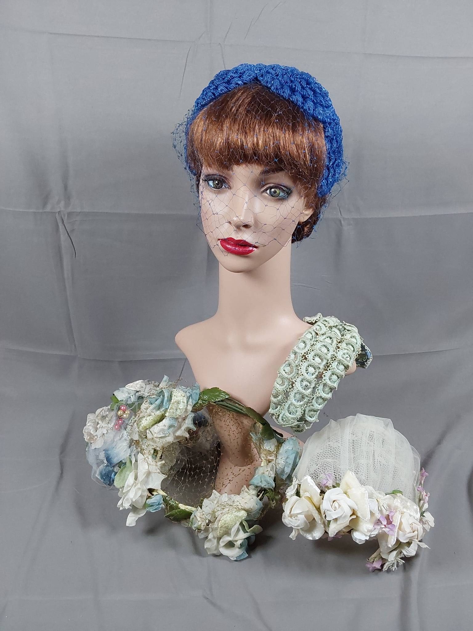 Group of 5 Vintage Cloche Hats: Group of 5 vintage cloche and headband hats. The lot includes a blue floral headband hat featuring a blue velvet wrapped armature, 4 large spun plastic flowers, a blue velvet bow, and a matching half 
