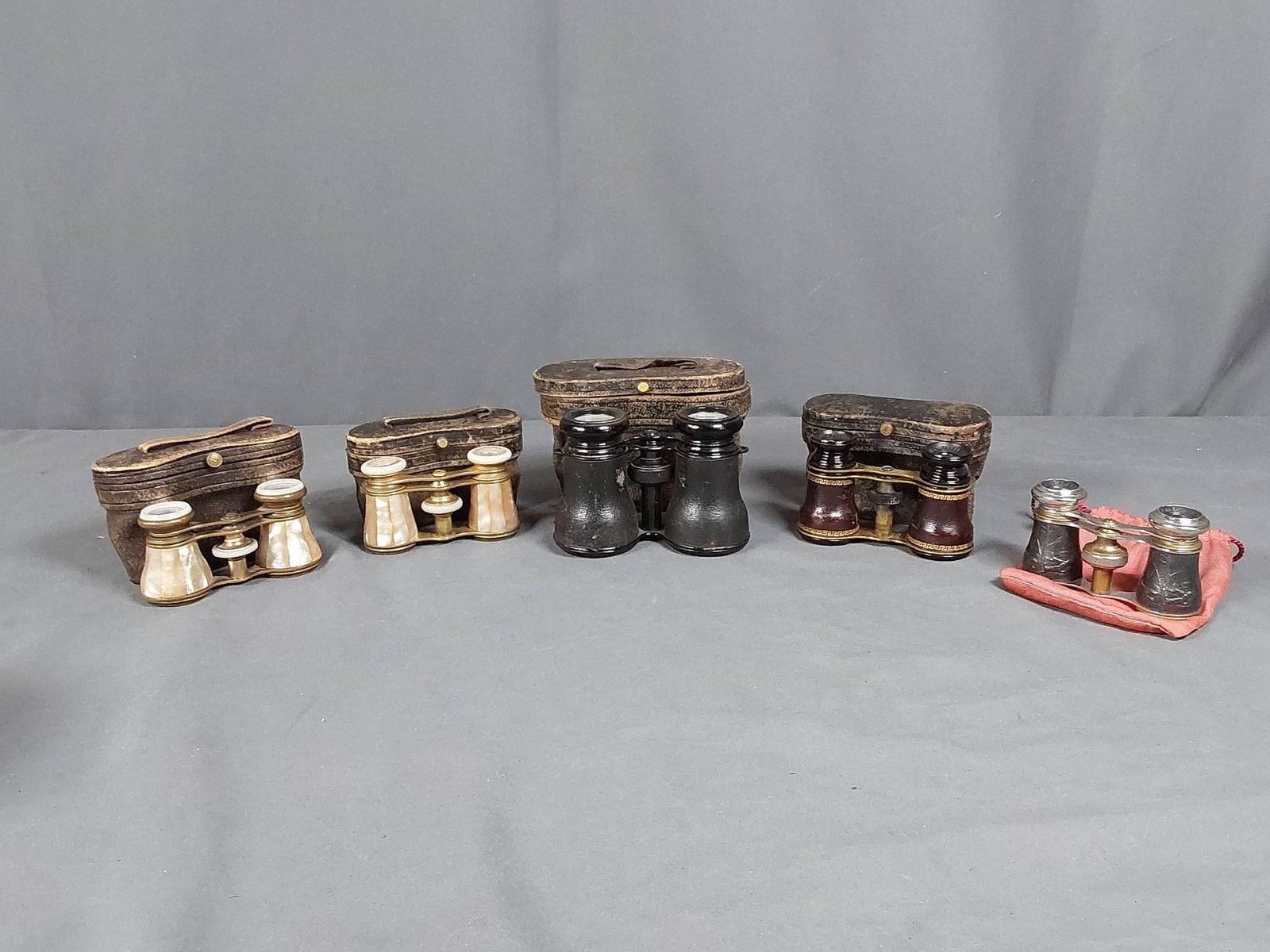 Five Pairs of French Opera Glasses: Collection of 5 pairs of 19th and 20th century French-made opera glasses and binoculars. Includes a pair of brass opera glasses by Lamavre with scopes covered in strips of mother of pearl, mother of p