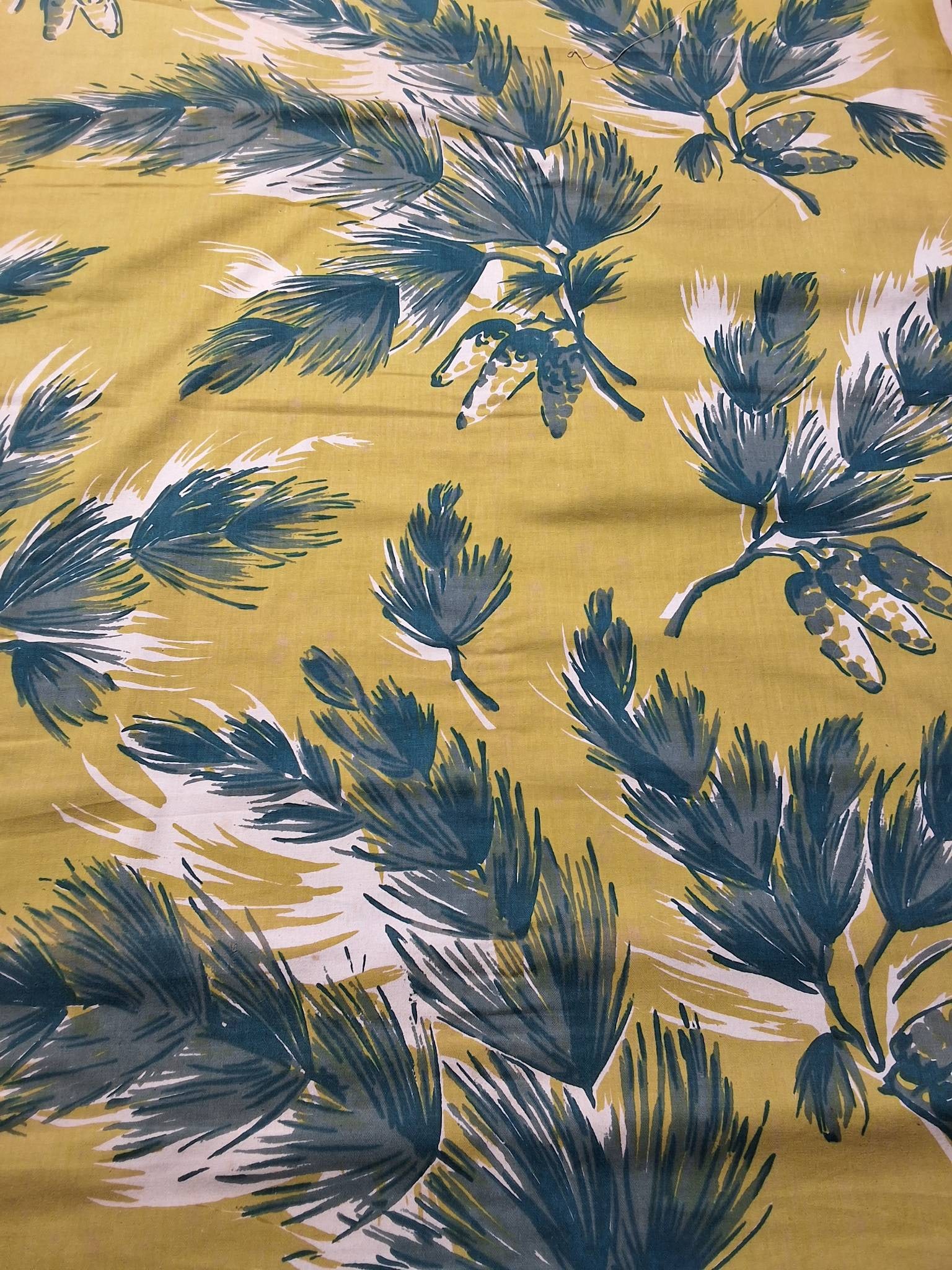 Vintage Fabric - Pine Grove Hand Print - Barret: Vintage cotton fabric measuring 37in by 45in, featuring a yellow by green background adorned with dark green pine boughs and pinecones. The design includes an artistic white cast alongside the pines.