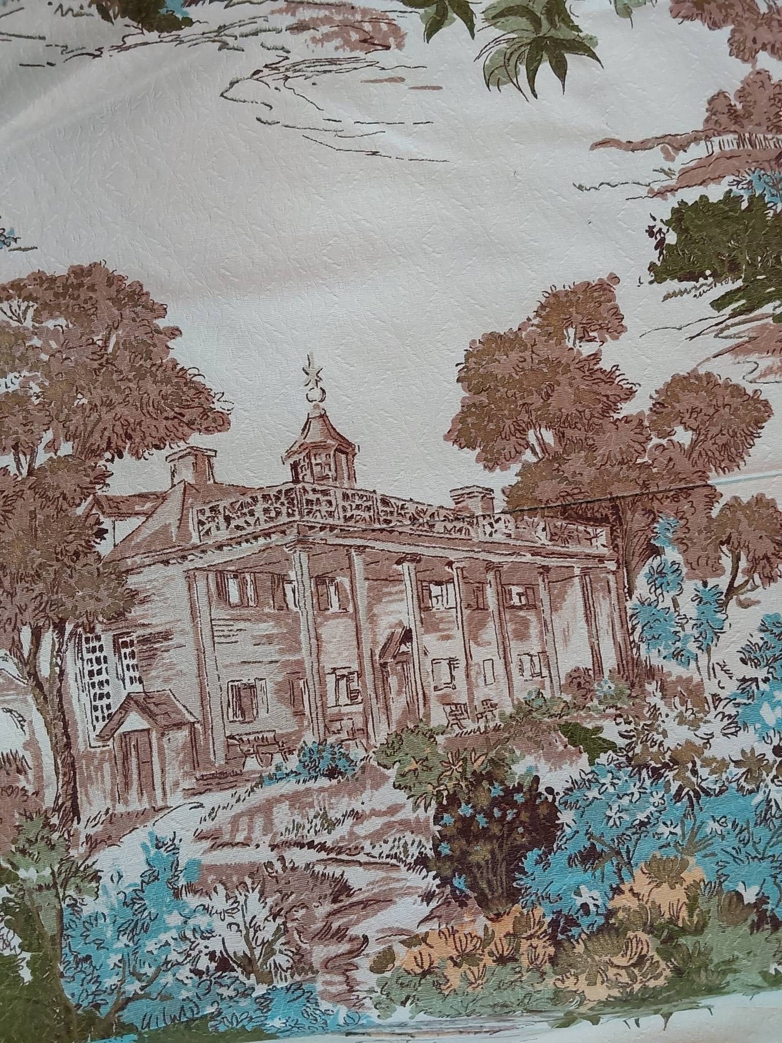 Vintage Barkcloth Fabric - Mount Vernon: Vintage barkcloth fabric featuring a white background and a scenic depiction of Mount Vernon. The piece measures 48inx252in. The design contains detailed illustrations of the historic Mount Vernon est