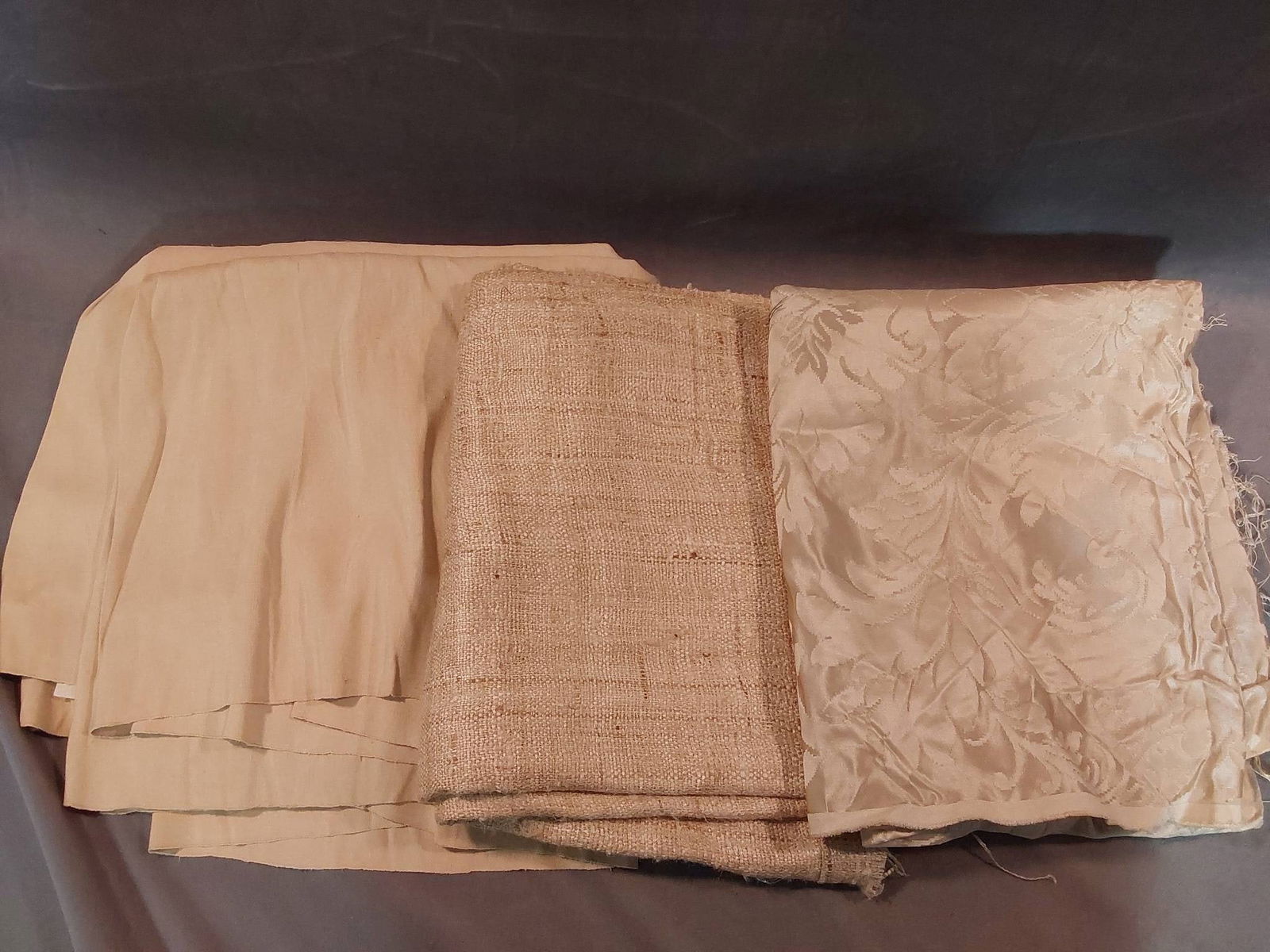 Vintage Fabrics - Linen, Wool, and Silk Blend: Vintage lot of three pieces of fabric, including linen, wool, and a silk blend. The linen measures 27inx216in and shows some spotting due to storage but is in good overall condition. The wool measures