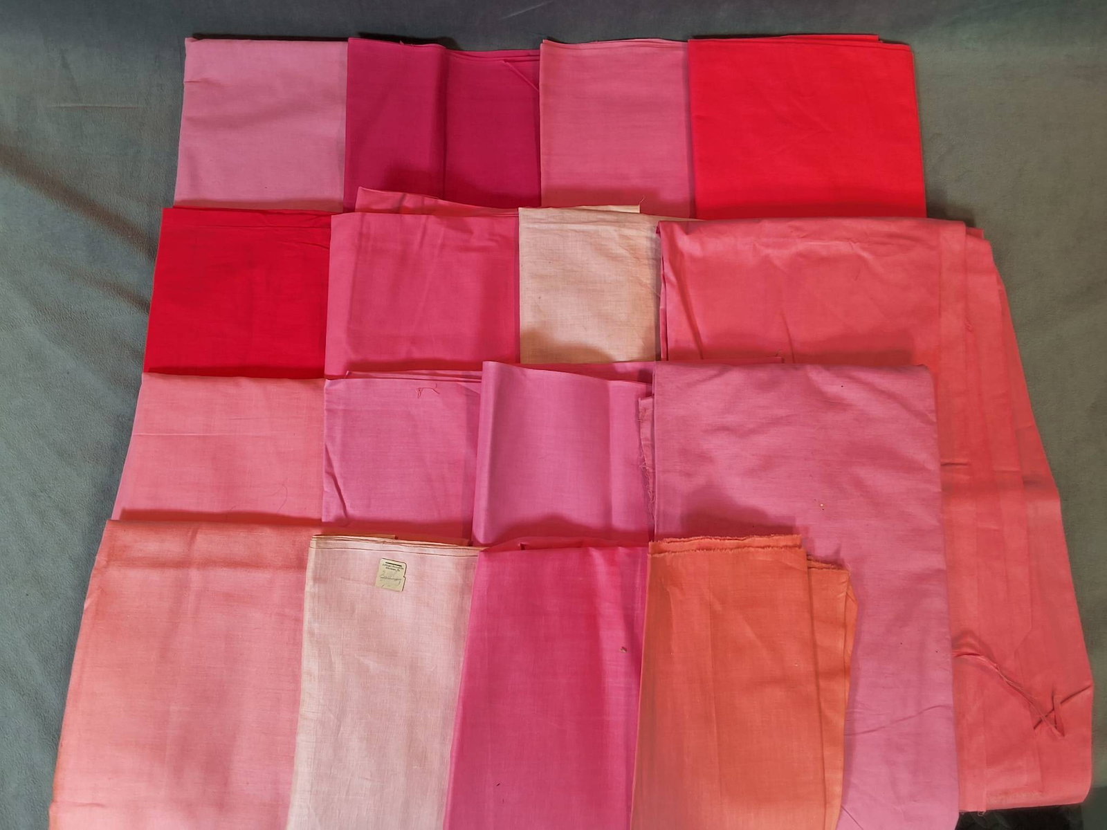 Pink Group B: A collection of vintage cotton fabric in 16 various by sized pieces, featuring shades of pink. Materials include cotton, cotton by satin, and polished cotton. The fabrics show signs of storage discolo