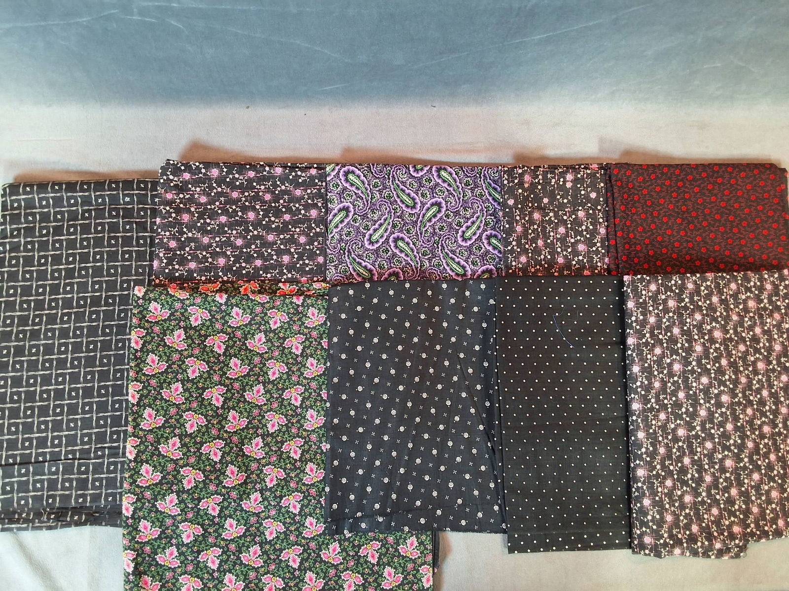 Antique Cotton Fabric - Floral, Paisley, and Grid Patterns: Antique cotton fabrics weighing 2.13 lbs, containing nine pieces with measurements as follows: 23.5in by 71in, 15in by 85in, 30in by 81in, 30in by 84in, 29in by 27in by 54in, 30in by 216in, 24in by 78