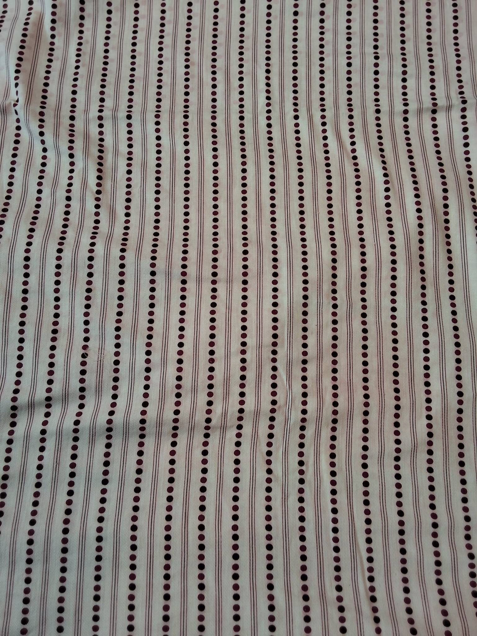 Antique Cotton Fabric - Cranberry and Brown Polka Dots: Antique cotton fabric measuring 25"x252" with a white background featuring polka dots and stripes in shades of cranberry and brown. Due to dye bleed, the white fabric has developed a faint pink hue wi