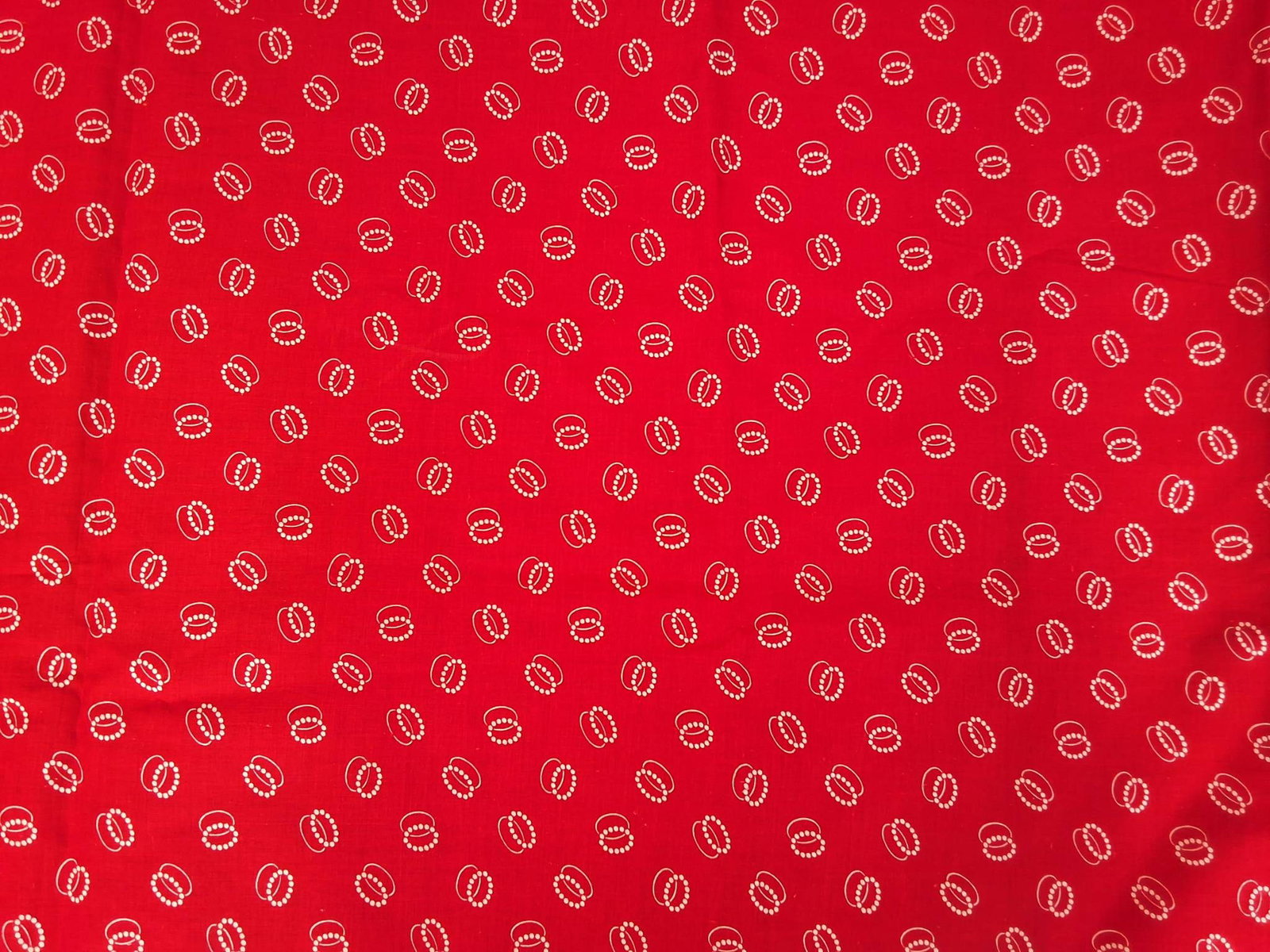 Antique Cotton Fabric - Red with White Ovals: Antique cotton fabric from the 1890s, measuring 24inx161in. Features a red background with white ovals, one formed with solid lines and the overlapping one with dotted circles. The fabric shows severa