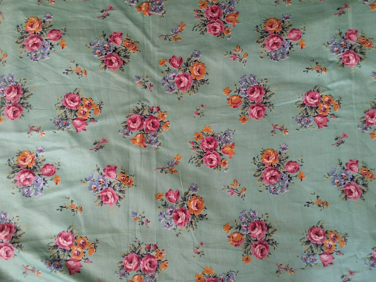 Vintage Cotton Fabric - Florals: Vintage cotton fabric measuring 36"x354", featuring an aquamarine base color with floral designs in pink, yellow, green, and blue. The designs include clusters of flowers, branches with singular flowe