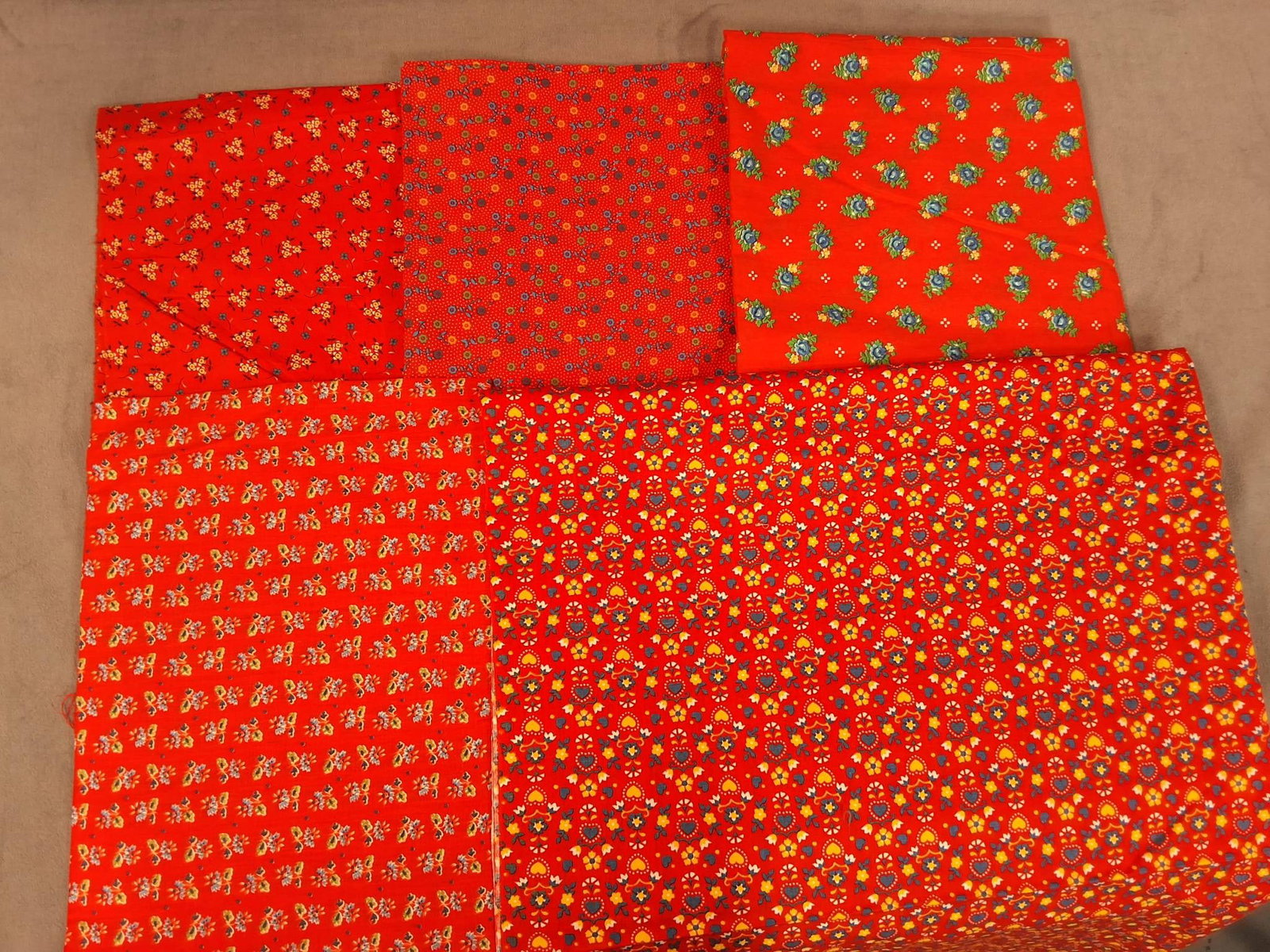 Vintage Cotton Fabric - Red with Florals: Lot of five vintage cotton fabric pieces weighing 2.02 lbs. Measurements include 35" by 170", 35" by 44", 44" by 108", 39" by 43", and 17" by 66". Each fabric features red backgrounds adorned with flo