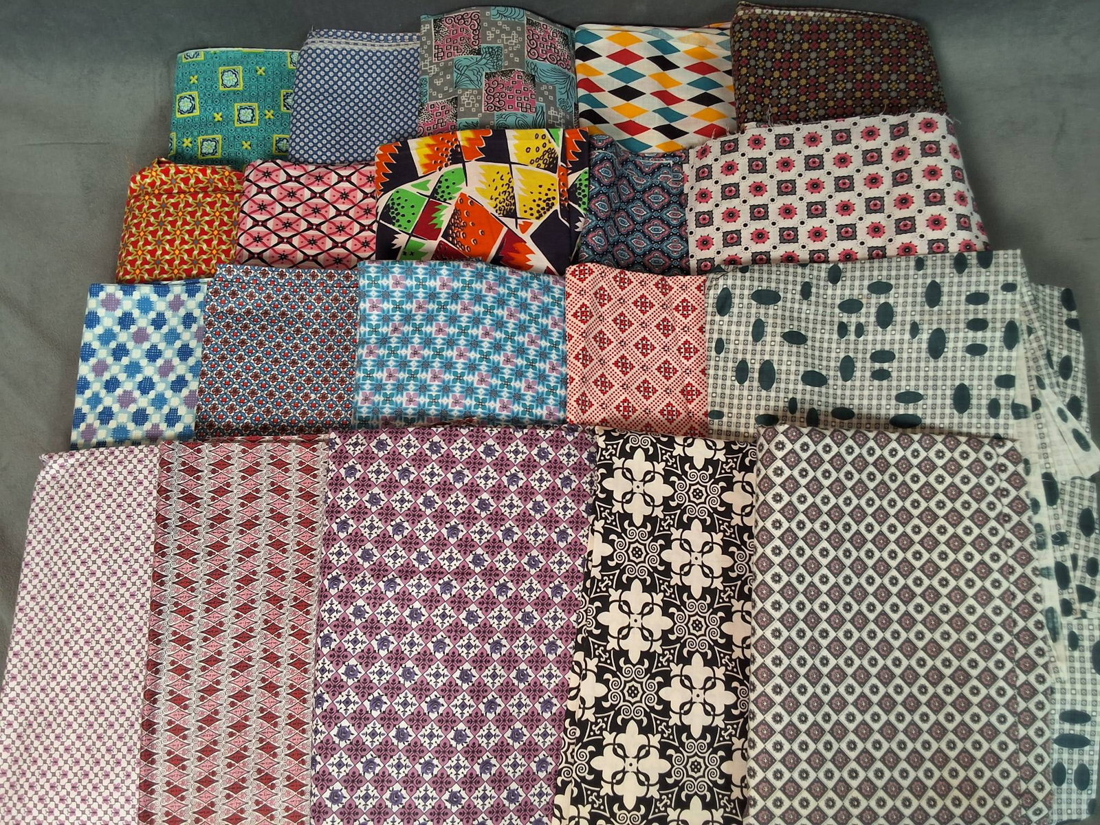 Vintage Cotton Fabric - Geometrics 10 lbs: 20 pieces of mid by century geometric fabric in various colorful designs, including pink, purple, red, green, yellow, and others. Total weight of the lot is 10 lbs. One piece displays faint discolorat