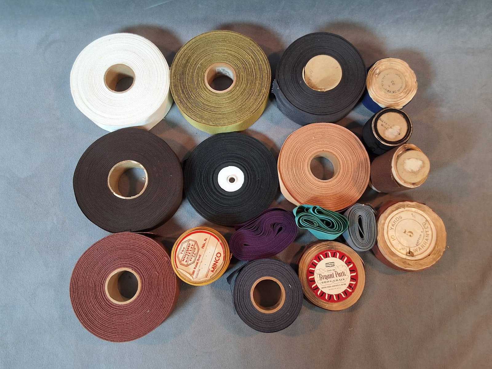 Vintage Grosgrain Ribbon Trim Collection: A collection of 17 grosgrain ribbon trim spools made with a blend of cotton, rayon, and acetate. The spools vary in length, with some having just over a yard, while others provide significant yardage.