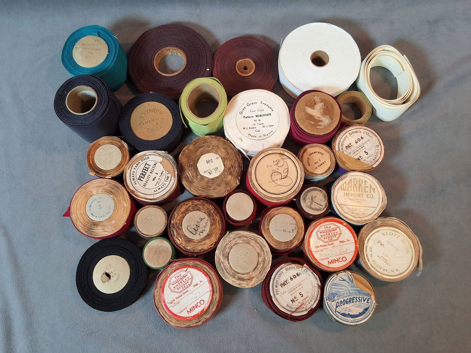 Vintage Grosgrain Ribbon Trim Collection: A collection of 32 vintage grosgrain fabric trim spools. These spools are made from cotton and rayon blends or cotton and silk blends. The collection includes grosgrain trims manufactured in both the