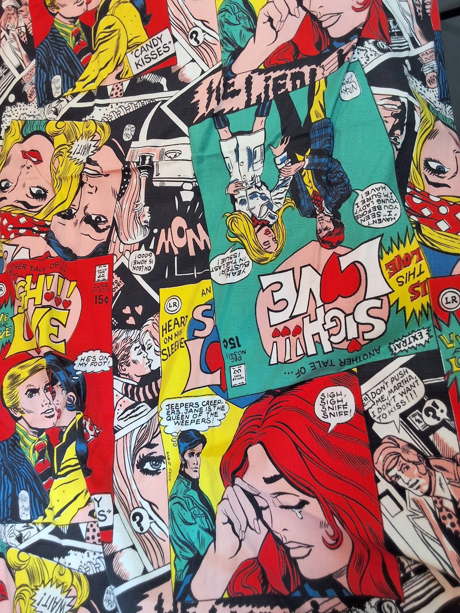 Cotton Fabric - Comic Panels: Colorful fabric panel featuring a vibrant comic art style design with bold illustrations and speech bubbles. The fabric measures 48inx213in, making it suitable for numerous applications. The design in