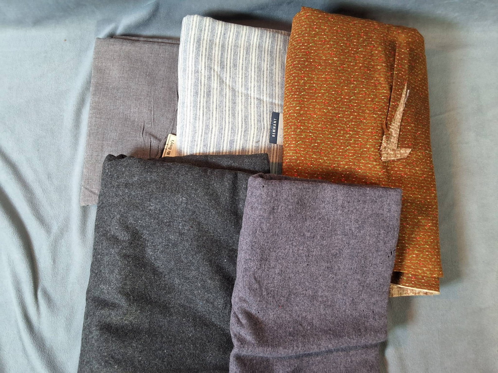 Collection of Mixed Wool and Cotton Fabrics: A lot of mixed vintage and antique wool and cotton fabrics in good condition. The fabrics include the following dimensions: 32"x61", 28"x74", 54"x72", 27"x190", and 29"x121". Stripes are displayed in 