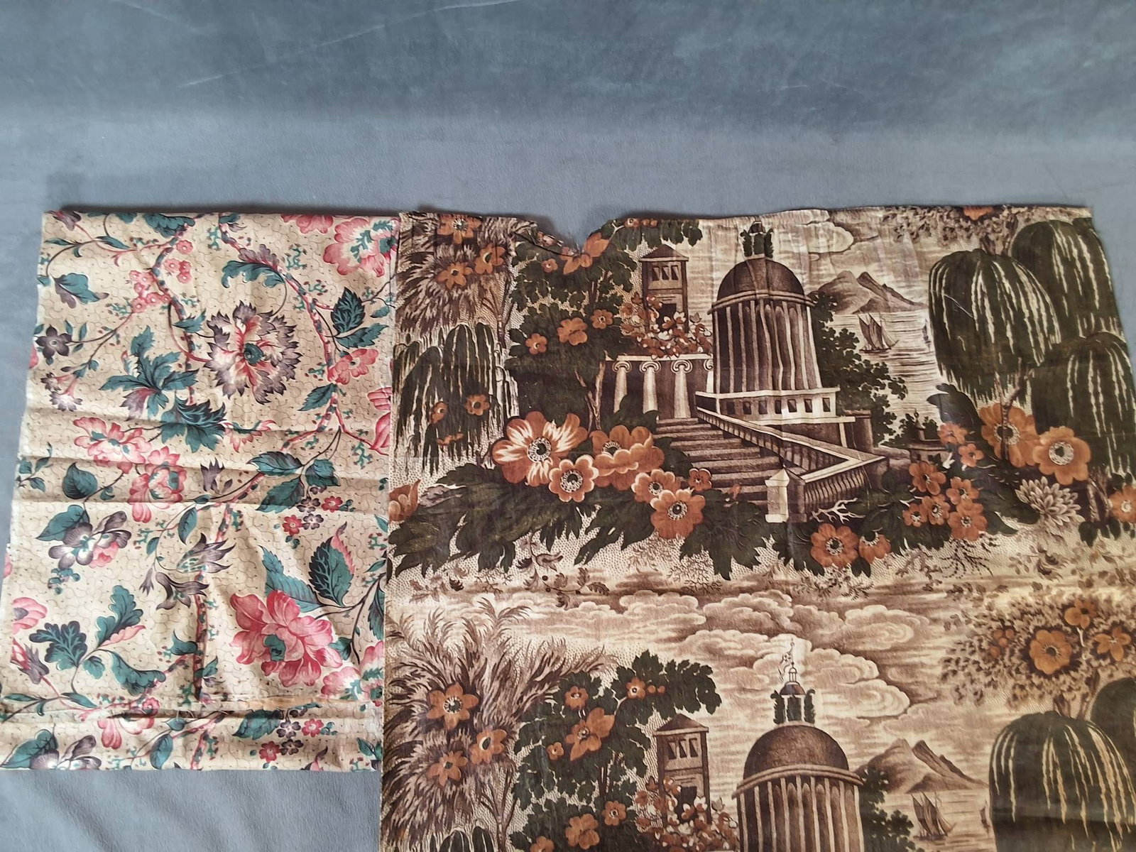 Antique Chintz Fabric c.1840 Pieces: Antique chintz fabric dating circa 1840, consisting of five pieces. Four pieces measure 23"x27" each and feature a classical design of a building surrounded by blooming florals, with a mountain and sa