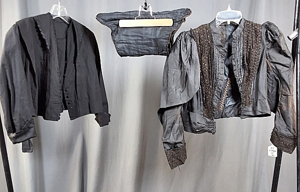 19th Century Black Silk Bodice and More: 19th Century Black Silk Bodice and More. The lot includes a mix of 19th century ladies black silk clothing. Featuring a late 19th century black silk mourning bodice featuring a short standing collar,