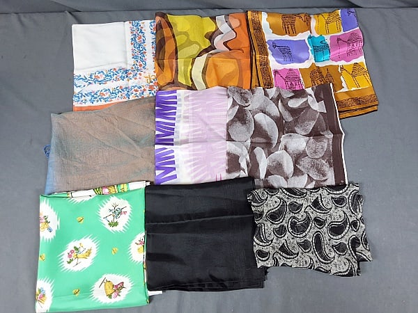 Assortment of 9 Vintage Scarves: This lot consists of nine pieces of handkerchiefs, and scarves. Featured are nine pieces of scarves, handkerchiefs, and an infinity scarf made from cotton, silk, vinyl, rayon, and more. There is one s