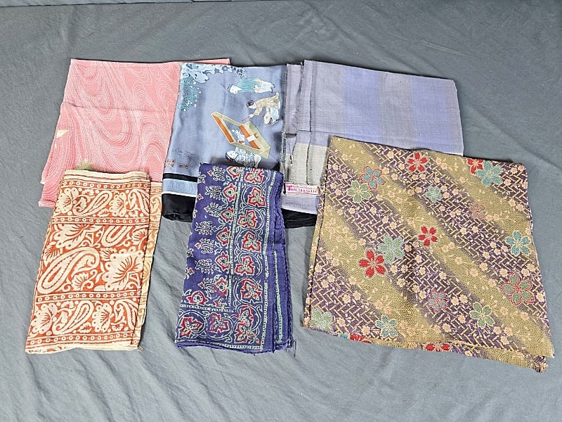Group of 6 Fashion Scarves: Group of 6 Fashion Scarves. The lot features six scarves and fabric. Featured are six scarves made from silk, rayon, and cotton that feature an assortment of patterns. There is a kerchief that is 23"x