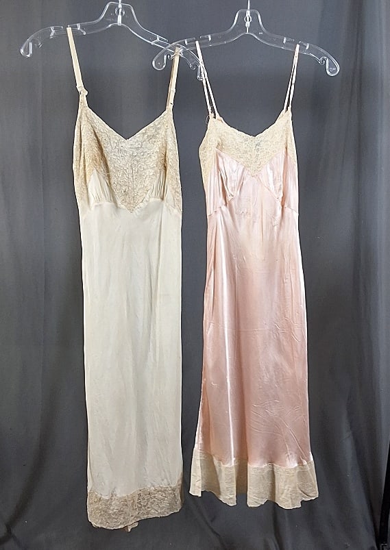 2 Vintage Night Camisoles: Two Vintage Night Camisoles. The lot consists of two vintage camisoles with lace hems. Featured are two vintage camisoles, one in pink and the other in white, with lace hems and collars. Both are slee