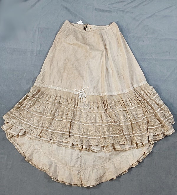 Antique 19th c. Petticoat: Antique 19th c. Petticoat. The lot consists of an antique 19th c. cotton petticoat. Featured is an antique 19th century cotton petticoat with a drawstring at the waist, ribbon inserts, and hand and ma