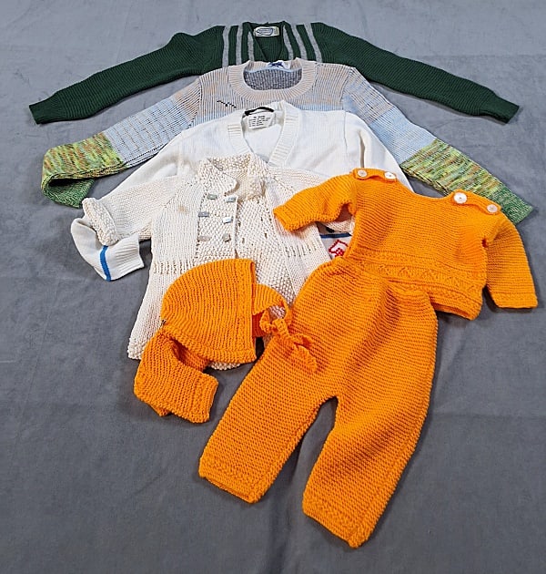 5 Children and Infant Sweaters and Set: Five Children and Infant Sweaters and Set. The lot consists of children and infant sweaters and a set. Featured are four children and infant sweaters and one orange set that includes a sweater, bonnet