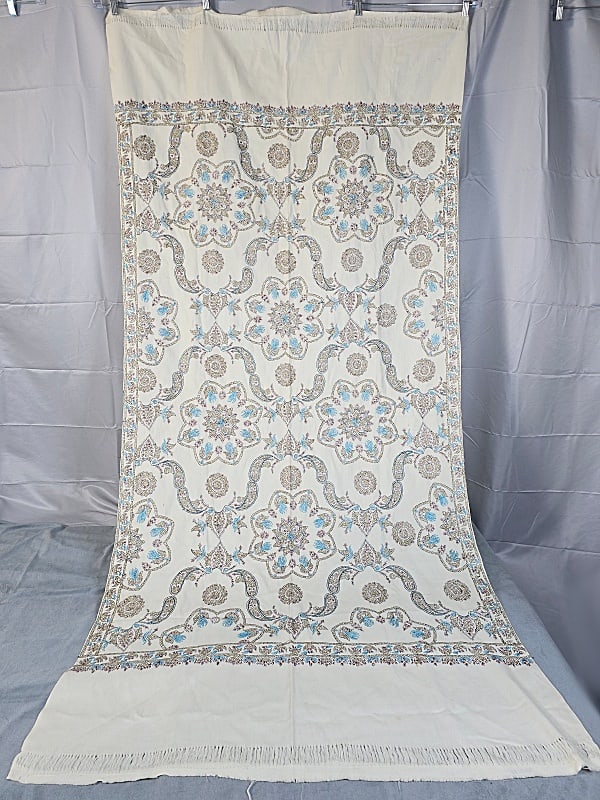 Southwest Asian Paisley Shawl - Hand Embroidered: Southwest Asian Paisley Shawl. The lot consists of a vintage southwest Asian paisley shawl. Featured is a vintage southwest Asian paisley shawl on a white cotton fabric with hand embroidered paisleys.