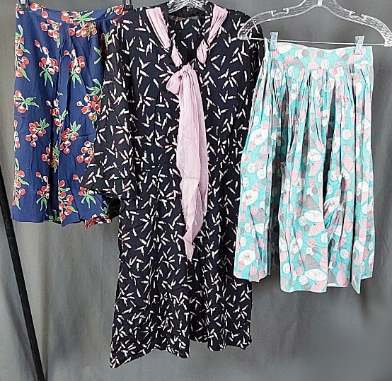Vintage c1950 Skirts and Dress: Three Vintage c1950 Skirts and Dress. The lot consists of vintage c1950 skirts and dresses. Featured are two vintage c1950 skirts and one dress which all have conversational prints featured. There is 