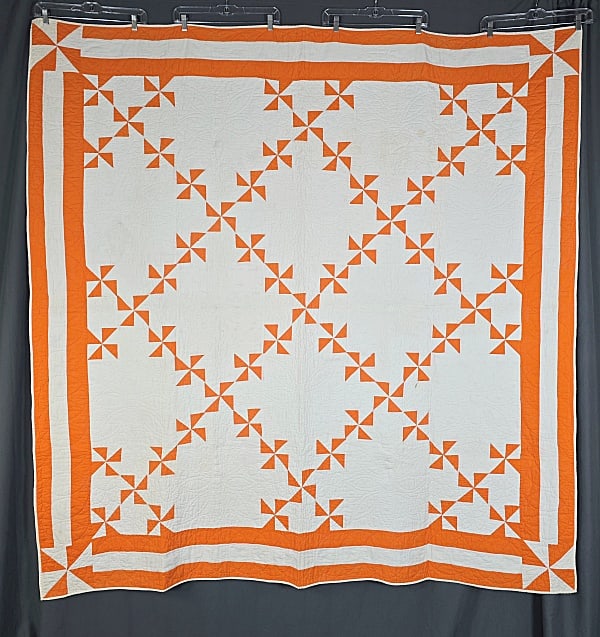 Antique c1880 Flutter Wheel Quilt: Antique c1880 Flutter Wheel Quilt measuring 72 by 73 inches. It is comprised of 25 blocks, 12 by 12 inches, set straight, 5 by 5, with 13 orange and white Flutter Wheel blocks and 12 alternating solid