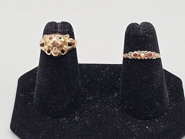 2, 19th Century 10K and 14k Gold Rings: 2, 19th Century Gold Rings. The lot includes a pair of late 19th and early 20th century yellow gold rings. Featuring a sz 3.5, 14K yellow gold art nouveau lion face ring with 1mm round garnet cabochon