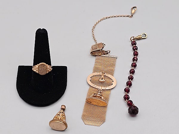 Group of 19th Century Watch Fobs and More: Group of 19th Century Watch Fobs and More. The lot includes a mix of late 19th century watch fobs and more. Featuring a 5 1/4'' long watch fob consisting of eleven 6mm faceted red glass beads with a w