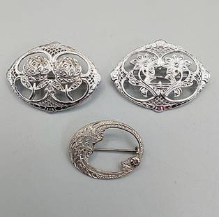 3 Vintage Sterling Filigree Brooches: 3 Vintage Sterling Filigree Brooches. The lot includes three art deco oval sterling brooches from the 1940s. Featuring a 1.65'' x 1.20'' oval sterling filigree brooch with two marcasite studded daisie
