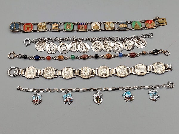 Group of 5 Vintage Bracelets- Souvenirs and More: Group of 5 Vintage Bracelets-Souvenirs and More. The lot includes a mix of 5 vintage bracelets. Featuring a 7.5'' long gold tone mini scarab bracelet featuring six hand carved 7mm x 6.8mm oval scarab 