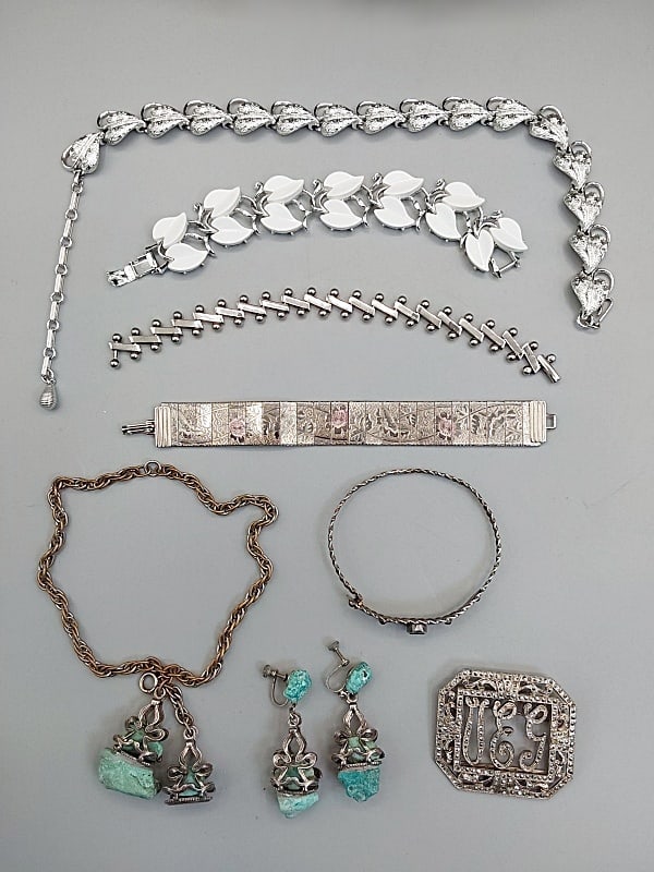 Group of Vintage Silver Costume Jewelry: Group of Vintage Silver Costume Jewelry. The lot includes a mix of vintage silver tone costume jewelry. Featuring an adjustable mid century 16'' long silver tone necklace by Coro comprised of heart sh