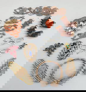 Group of Art Deco Shoe and Dress Clips: Group of Art Deco Shoe and Dress Clips. The lot includes a mix of vintage art deco shoe and dress clips. Featuring two pairs of 1.96'' x .82'' bow shaped shoe clips with conical centers full covered i