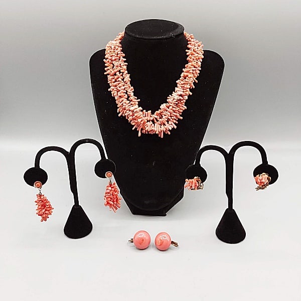 Group of Vintage Coral Jewelry: Group of Vintage Coral Jewelry includes a 15" triple strand coral branch necklace with filigree box clasp. Along with 3 pairs of coral clip on and screw clip earrings. One pair is coral colored glass.
