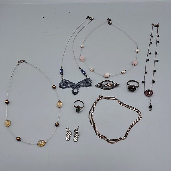 Sterling Silver and Costume Lot: Sterling Silver and Costume Lot. Includes a Sterling Silver and green stone ring; cut steel and colored gemstone 925 pin; pair of rhinestone and 925 earrings, one with broken post; Artisan Hand Tatted