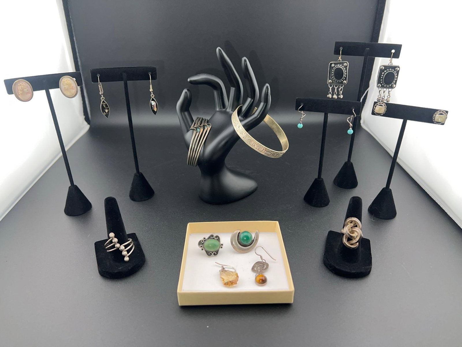 Unmarked Silver Jewelry: Grouping of unmarked silver jewelry - most (if not all) of the silver would grade lower than .900 if tested. The pieces include an Egyptian style hieroglyph embossed bangle bracelet (marked sterling 9