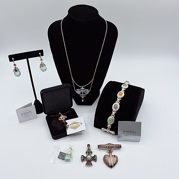 Judith Ripka and More: Four pieces of Judith Ripka sterling jewelry to include a 1 5/8" long cross pendant with center faux pearl and rhinestones, a 1" drop pendant, a 1 3/4" long heart pin and a 7 3/8" long cabochon scarab