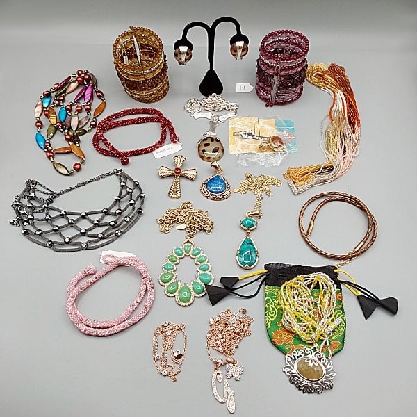 Signed Costume Jewelry: Sixteen pieces of signed costume jewelry to include Two "Hot in Hollywood" 3" long beaded cuff bracelets; a Sally C. 2.5" cross pendant and 48"cultured pearl / mother of pearl necklace; A Himalayan 19