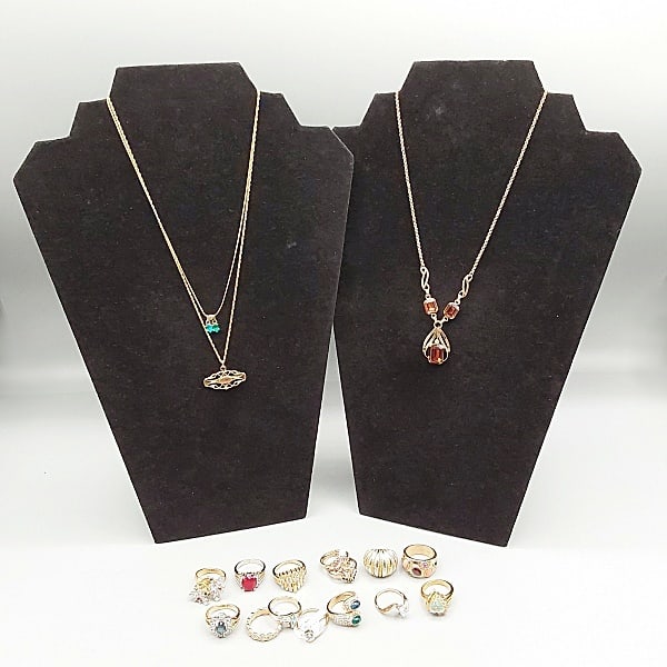 Gold Filled or Plated Jewelry Grouping: Sixteen pieces of gold filled or gold plated jewelry to include 13 rings mostly sized between 7 and 8, A Victorian bucked used as a pendant, a necklace with blue and green stones and a gold filled nec