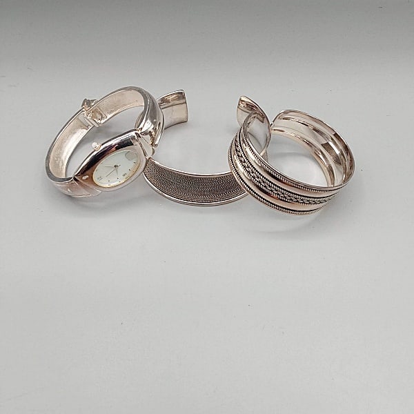 2 Sterling Cuff Bracelets Plus Watch: Lot includes a Balia Braided cuff bracelet (2 3/4" across) and one with a balia braided design cuff bracelet (2 1/4"). Also a Robert Lee Morris (RLM Studio) quartz driven wrist watch with sterling sil