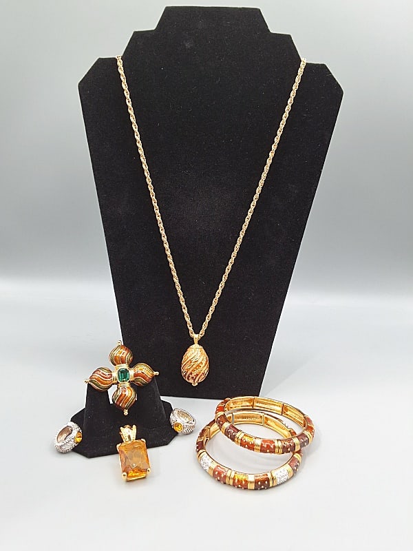 Joan Rivers Grouping: A Joan Rivers gold tone red and orange ombre faberge enamel pendant necklace (24" chain, Pendant is 1 5/8"), two similar gold tone elastic link bracelets - one with rhinestone links (3" Diameter), a 1