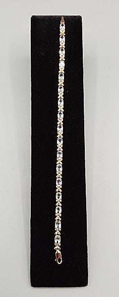 14K Tennis Bracelet: A 7" long marked 14K yellow-gold tennis bracelet with aquamarine stones and a domino mark (Weight with stones 5.85g)If you have any doubt, please ask questions! We will provide extra pictures, or can