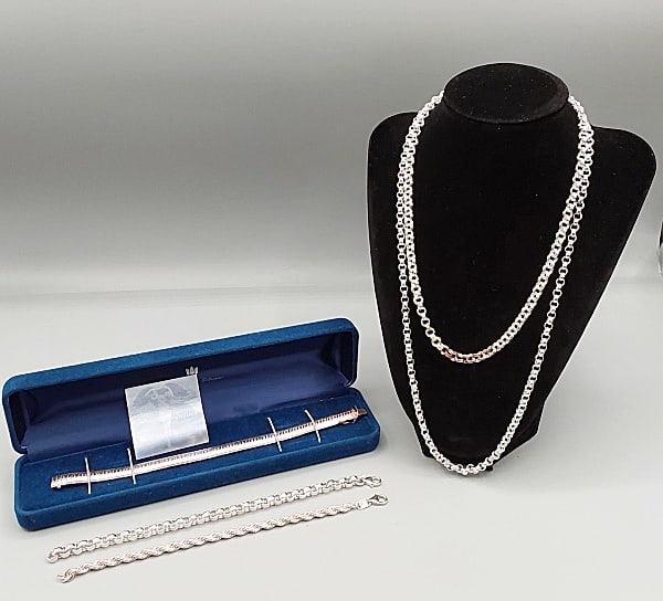 Ultra Fine .999 Silver Jewelry: Five pieces of ultra fine .999 silver jewelry to include: a 7 1/2" engraved flexible bracelet; a 7 1/4" rolo chain bracelet; a 7 1/4" rope chain bracelet; a 22" rolo chain necklace and a 17 1/2" doubl