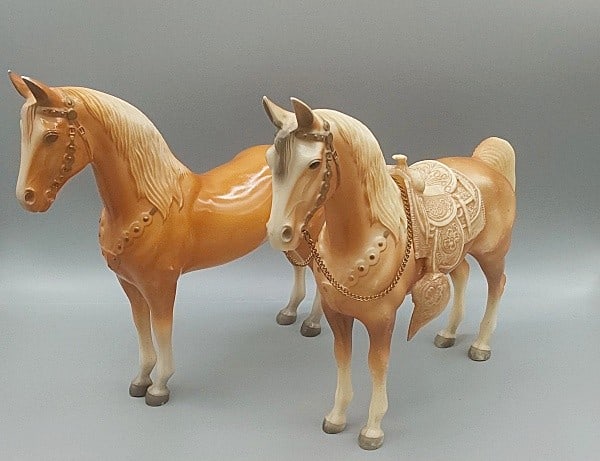 2 Breyer Western Horses #57: 2 Breyer Western Horses #57. Two traditional Breyer horses in their original palomino finishes. One is in fair condition with many scratches and rubs on both sides and has original saddle. The other i