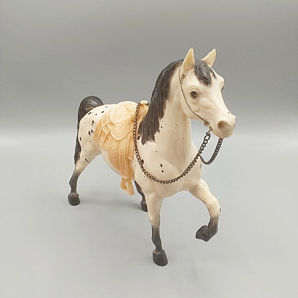 Breyer Cheyenne Western Prancing Horse #115: Breyer Cheyenne Western Prancing Horse #115. Traditional Breyer horse in original semi-gloss black leopard appaloosa finish with saddle. In good condition with a chip to the left ear, tarnish on reins