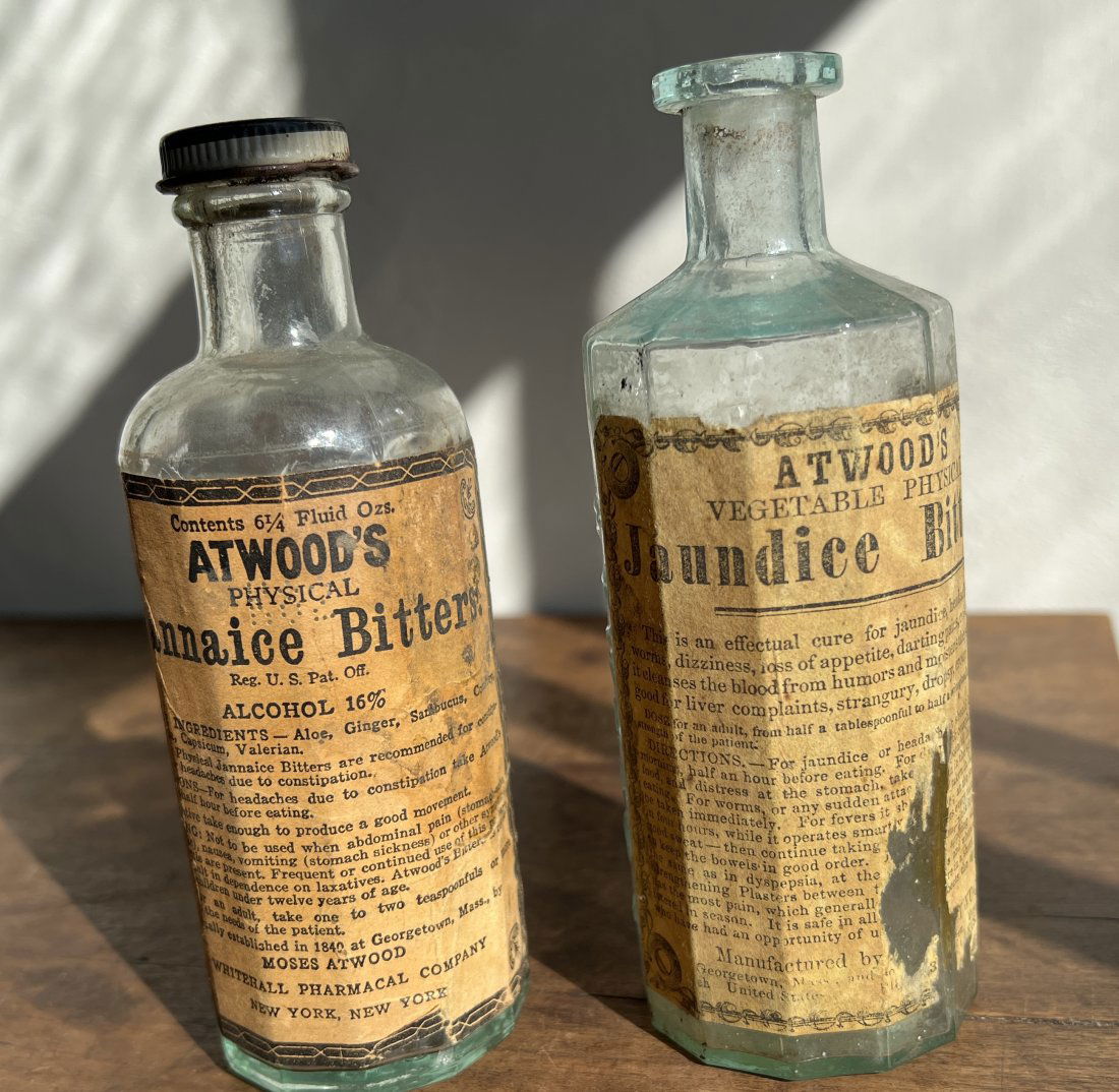 Pair of Atwood's Jaundice Bitters Bottles w/ Labels Moses Georgetown Mass: One is marked Moses Atwood Georgetown Mass and the other later one is marked formerly made by Moses - NY NY. Approx 5.75 inches tall. All the bottles in this auction came from a collection and are fre
