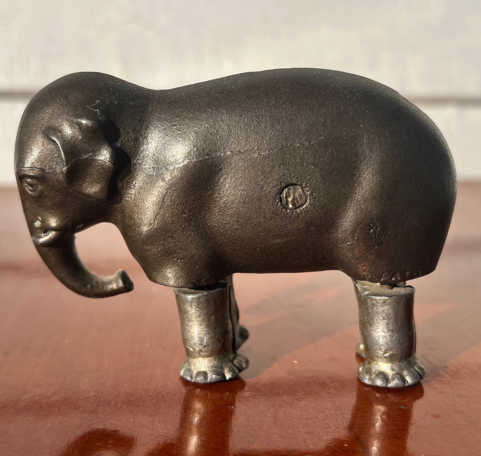 Pat. Cast Iron Elephant Mechanical Toy W. N. Co.: All original and signed as shown. The line shown along its side is not a hairline but a in making cast. Very good original shape as shown. Approx 2.5 by 3.5 inches.
