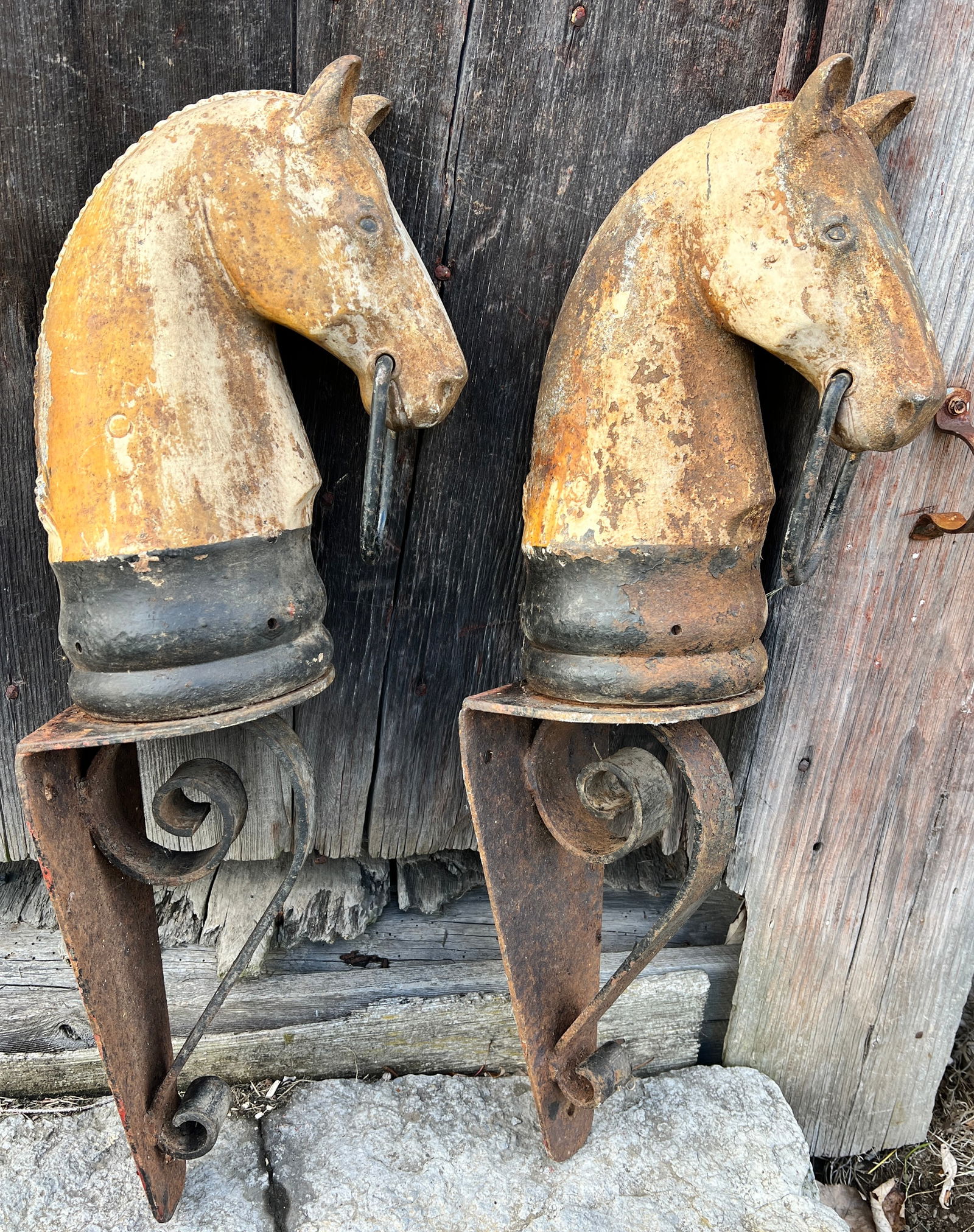 Antique Pair of Folk Art Cast Iron Early Horse Head Hitching Posts: Very nice old patina color on this early pair of Horse Heads w/ early iron hanging brackets which are heavy duty as Heads are heavy. These are solid and would hang proudly. What's to Love - Great heav