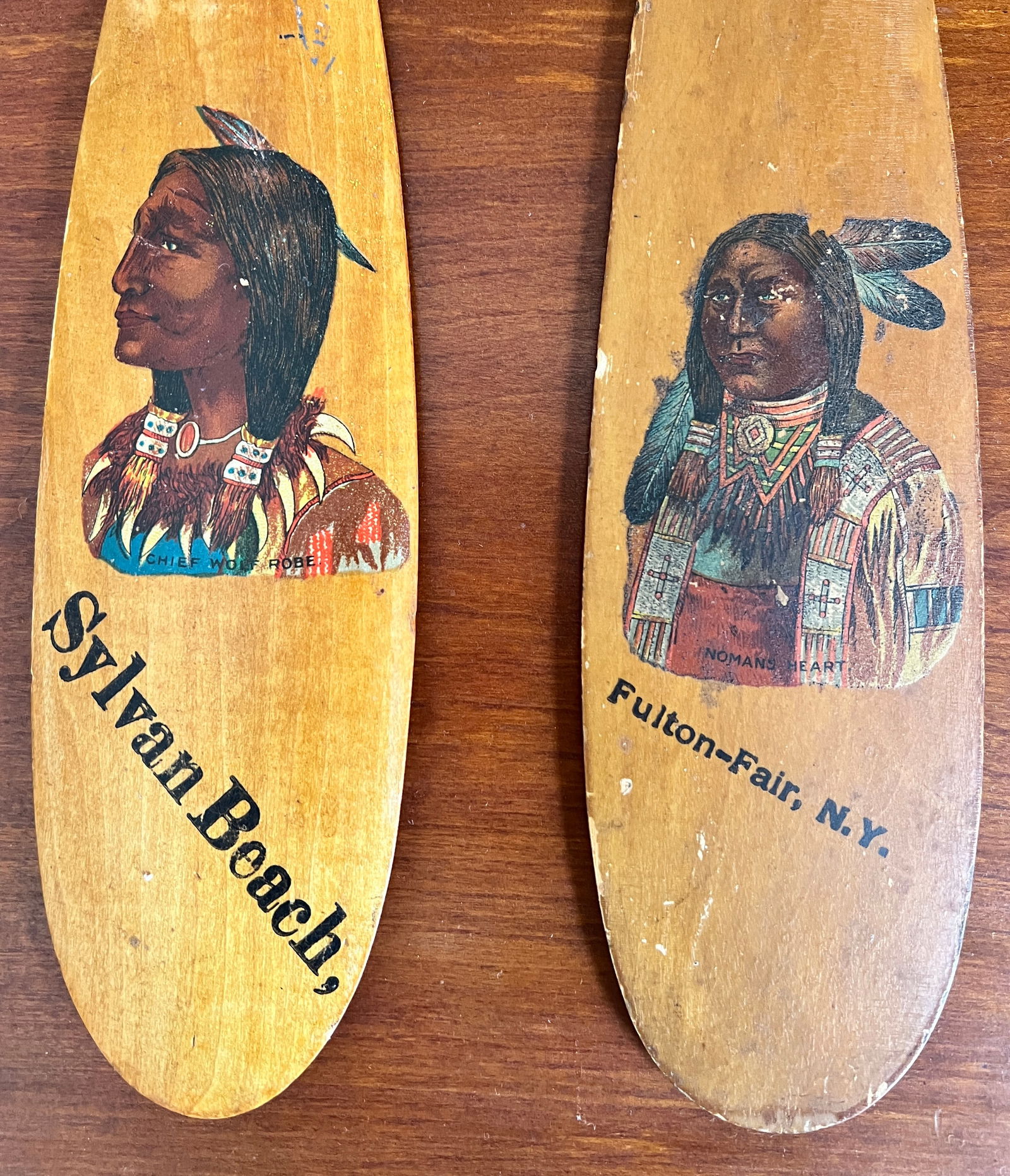 Pair of New York Native Indian Souvenir Portrait Canoe Paddles Adirondack: 2 nice decal Indian Chief Canoe Paddles one Nomans Heart from Fulton NY and other Chief Wolf Robe Sylvan Beach NY. What's to Love - The Fulton Fair had huge crowds back at the turn of the century - li